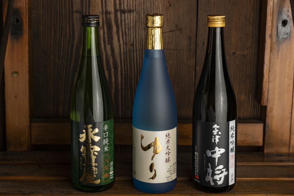 From left: 'Eihoya Karakuchi Junmai Hattan Nishiki,' 'Yuri Junmai Daiginjo,' and 'Aizu Chujo Junmai Ginjo Yumenokaori.' The 'Yuri' brand was created by Yuri and her mother.