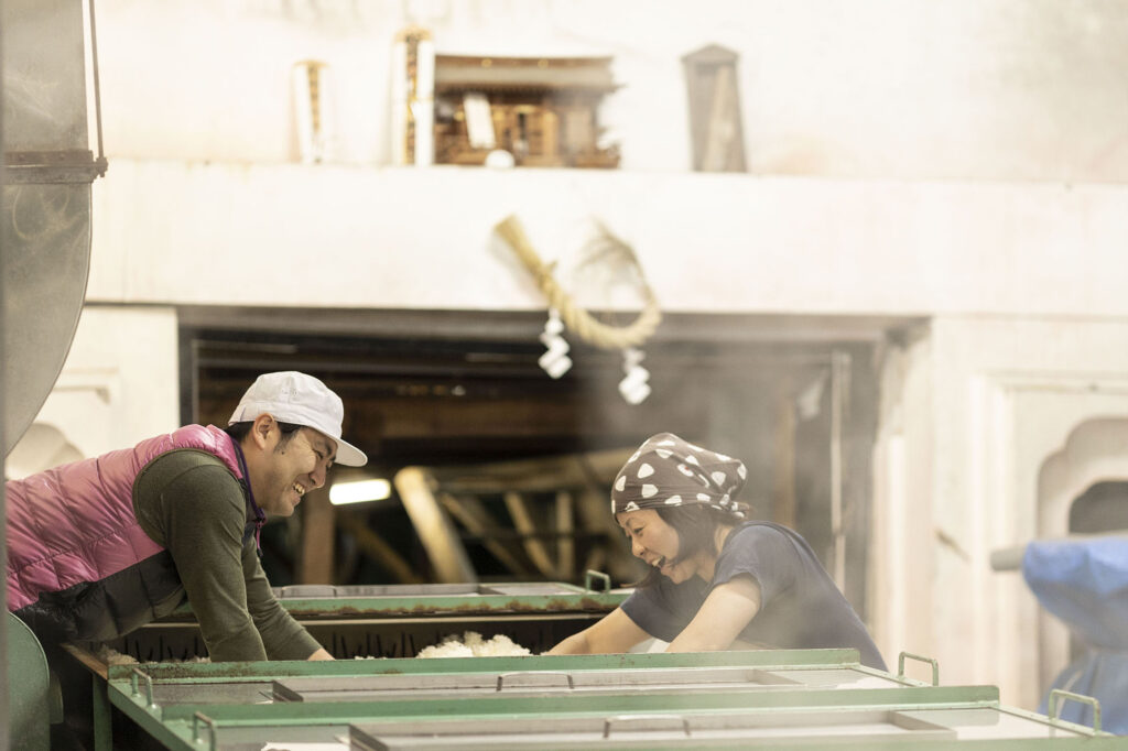 The cooling process, to bring down the temperature of the freshly steamed rice. The sake rice is cooled evenly by hand to prevent any inconsistencies or variation.